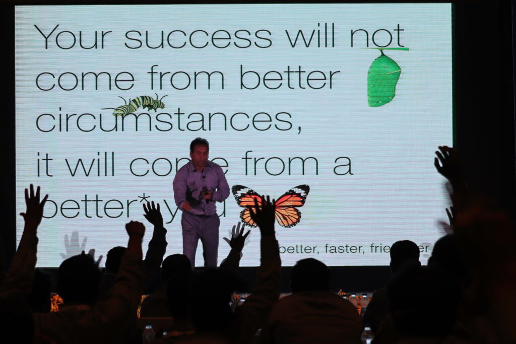 a keynote speaker with slide in the background